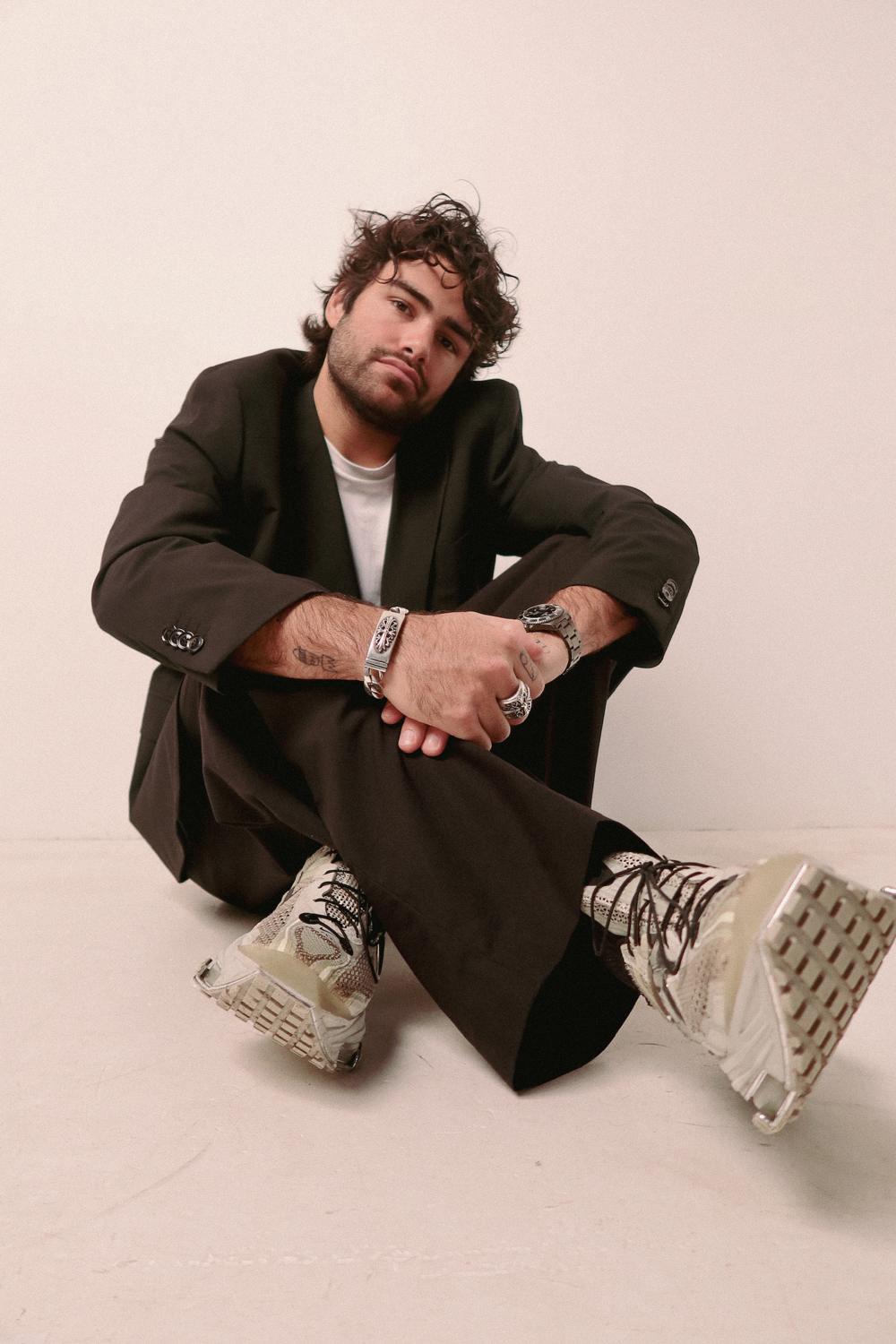 Mooglie press portrait in a black suit